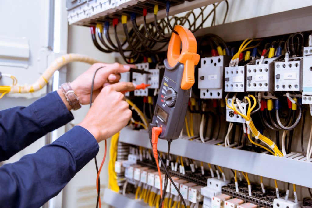 electrician testing electric current control panel